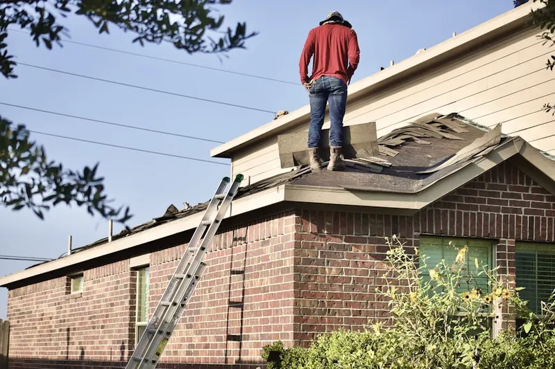 Professional roofer working on a residential roof in Villa Heights
